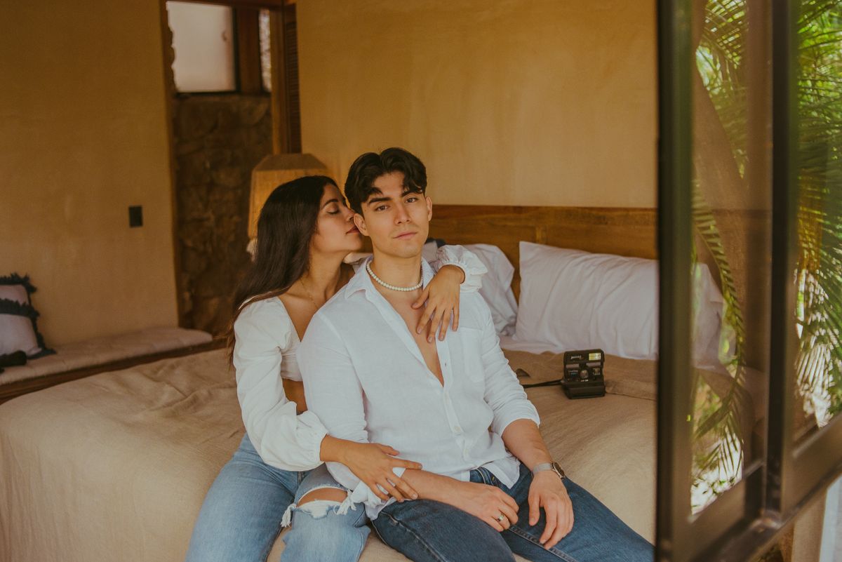 Young couple sitting together in a hotel room