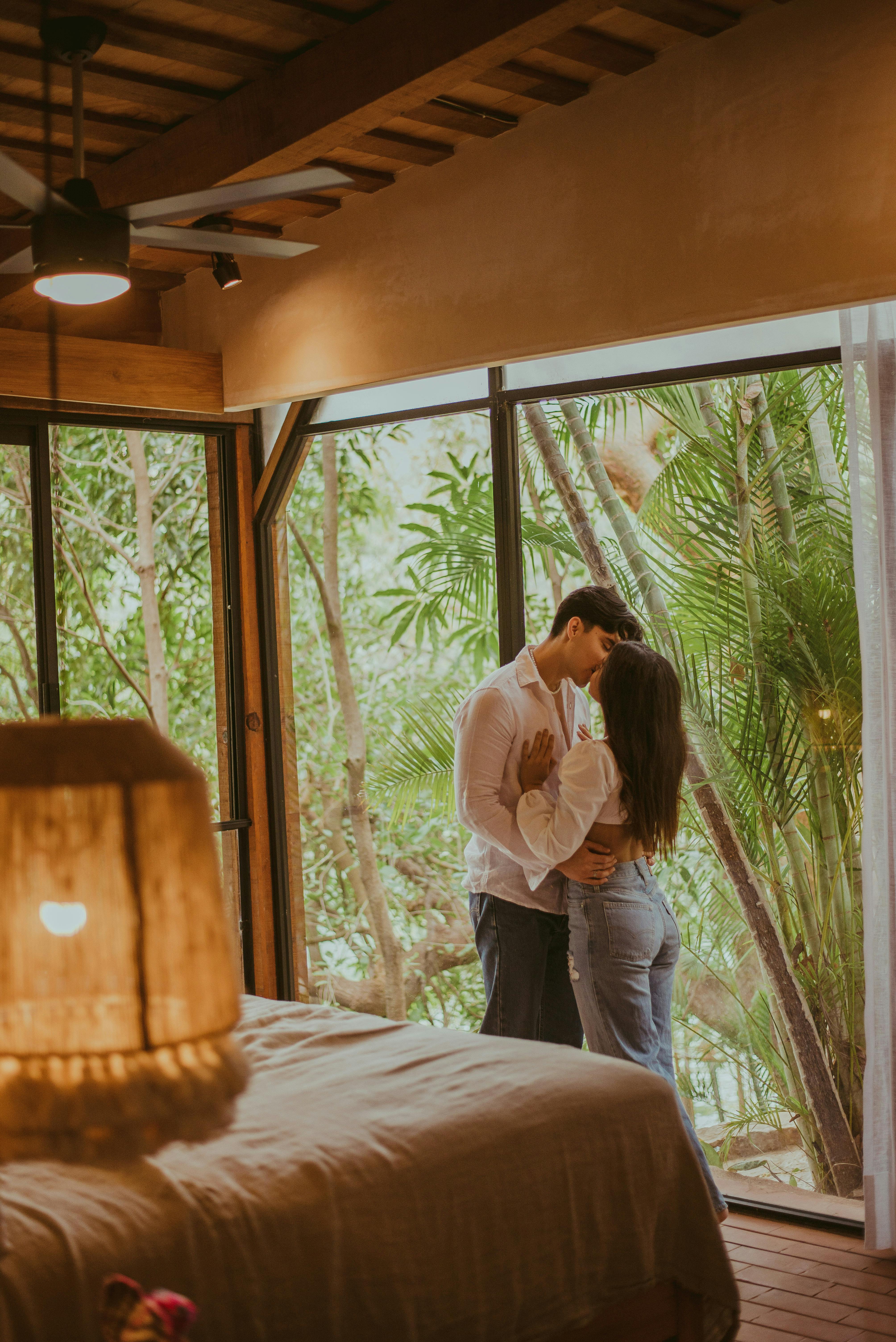 Young Couple Kissing in a Hotel Room · Free Stock Photo