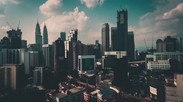 Stunning cityscape of Kuala Lumpur featuring iconic Petronas Towers at dusk.