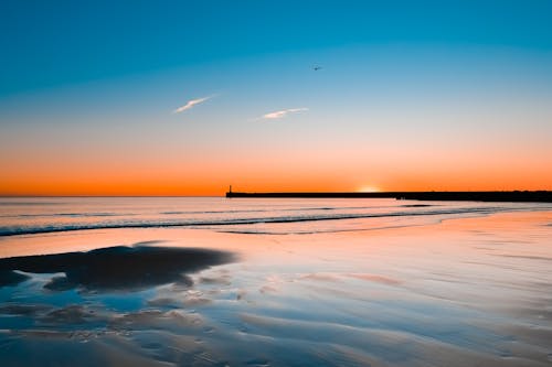 Scenic View Of Ocean During Sunset