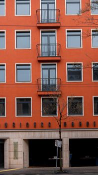 Vertical shot of a vibrant urban residential building facade with balconies and windows.