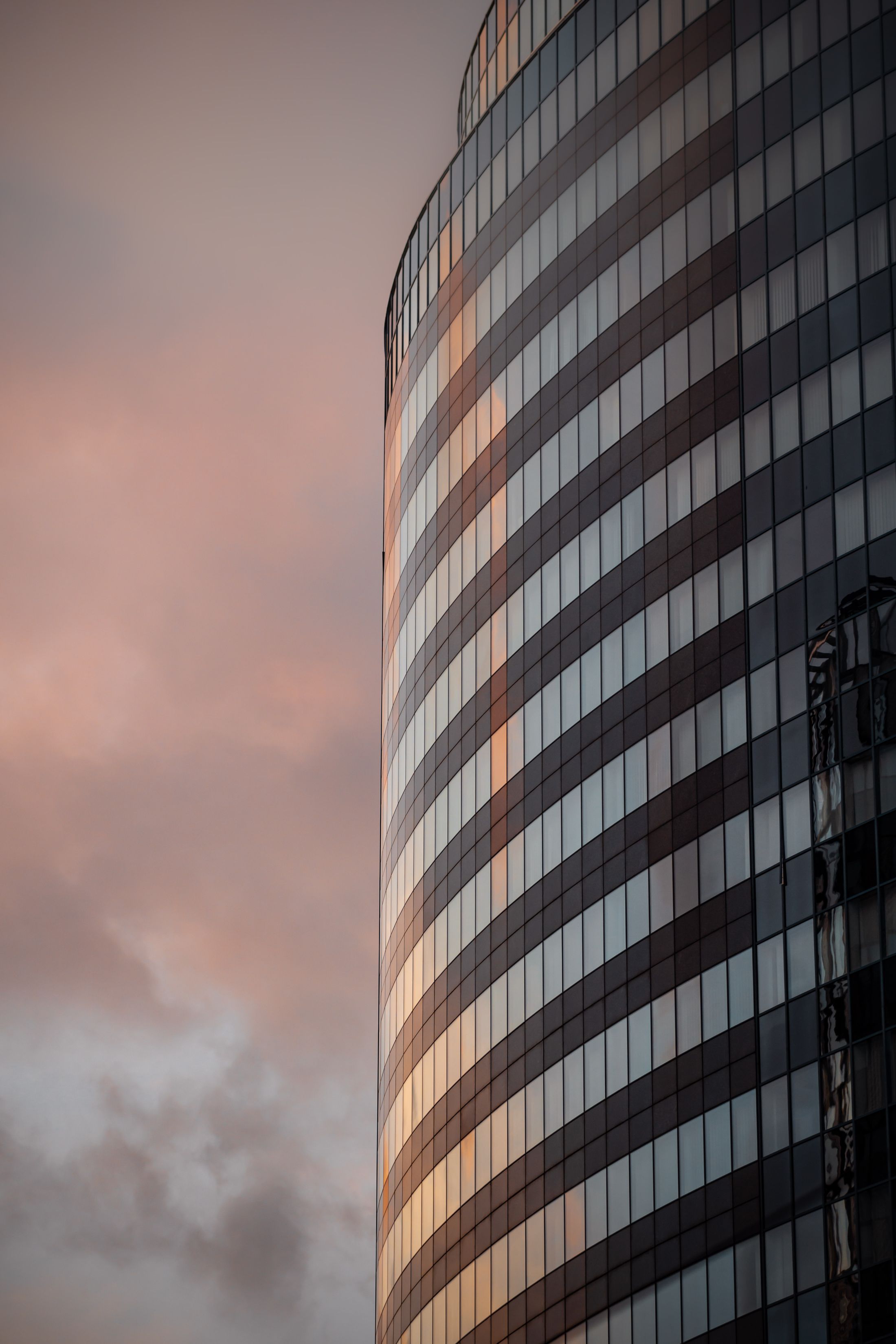 Modern office building glowing at sunset