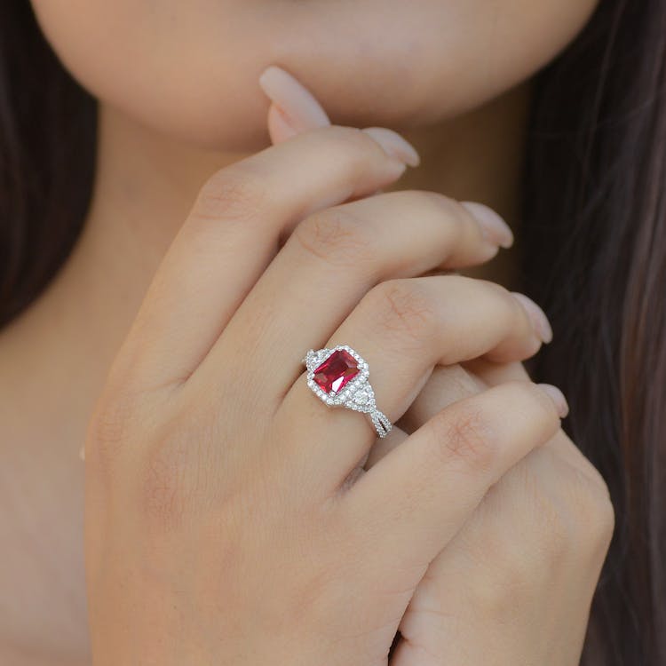 Close-up Of Woman Wearing A Silver Ring With A Ruby Stone 