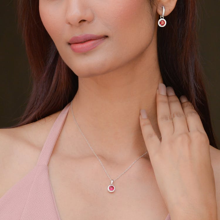 Close-up Of A Young Brunette Wearing A Silver Necklace With A Pink Gem Stone 