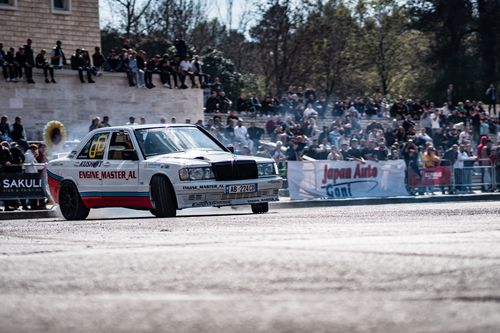 Free A thrilling shot of a car drifting at a lively urban motorsport event, showcasing excitement and speed. Stock Photo