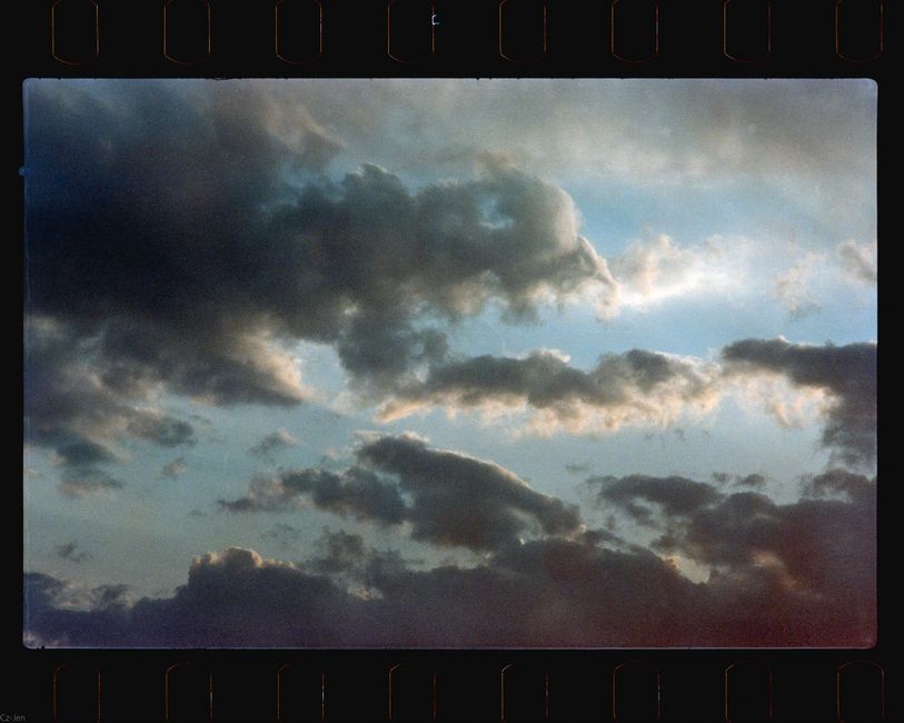 Captivating view of a dramatic cloudscape at sunset, showcasing moody skies in vintage film style.