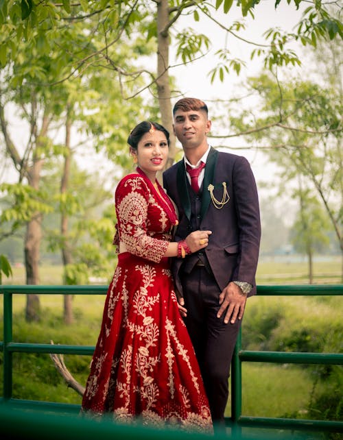 Man in Suit Standing with Woman in Traditional Clothing