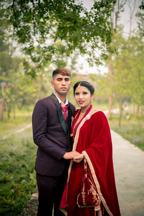 Woman in Traditional Clothing and Man in Suit