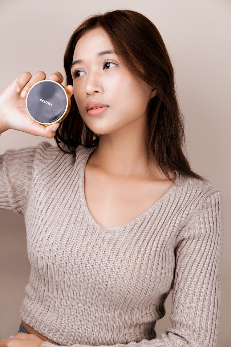 Woman Holding A Beauty Product 