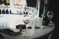 A close-up of champagne glasses and bottle on a table in Aÿ-Champagne, France.