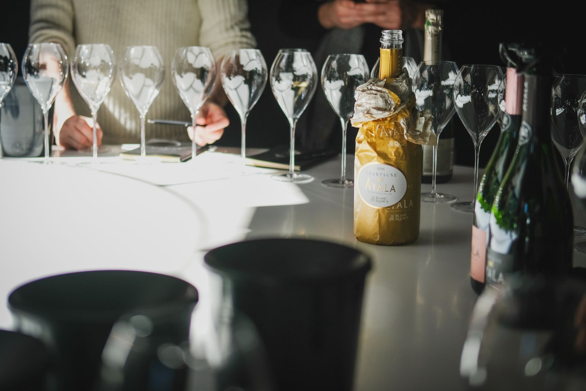 Close up of shot glasses filled to various levels with clear liquor