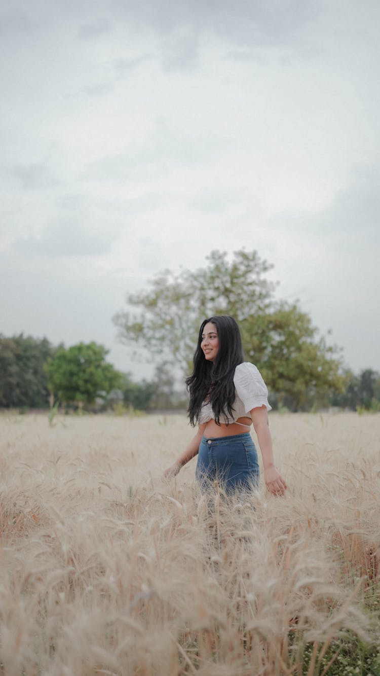 A Young Woman On The Field In Summer