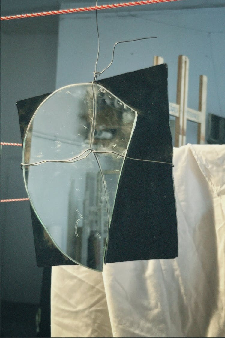 Broken Mirror Hanging On String