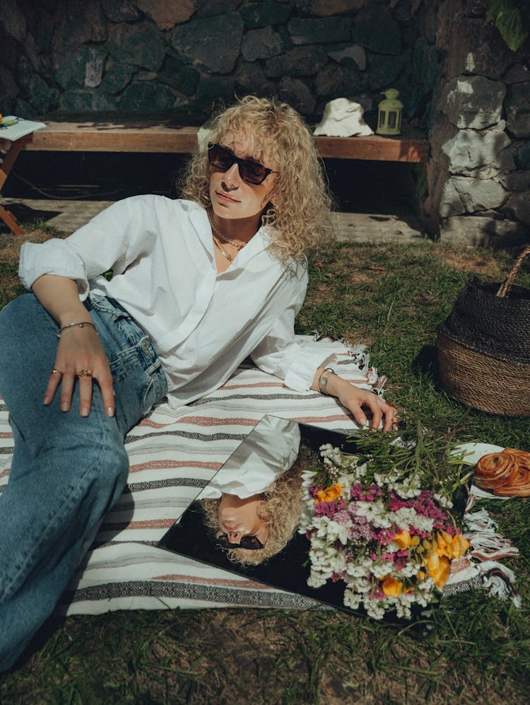 Young Woman Lying On The Blanket On The Grass