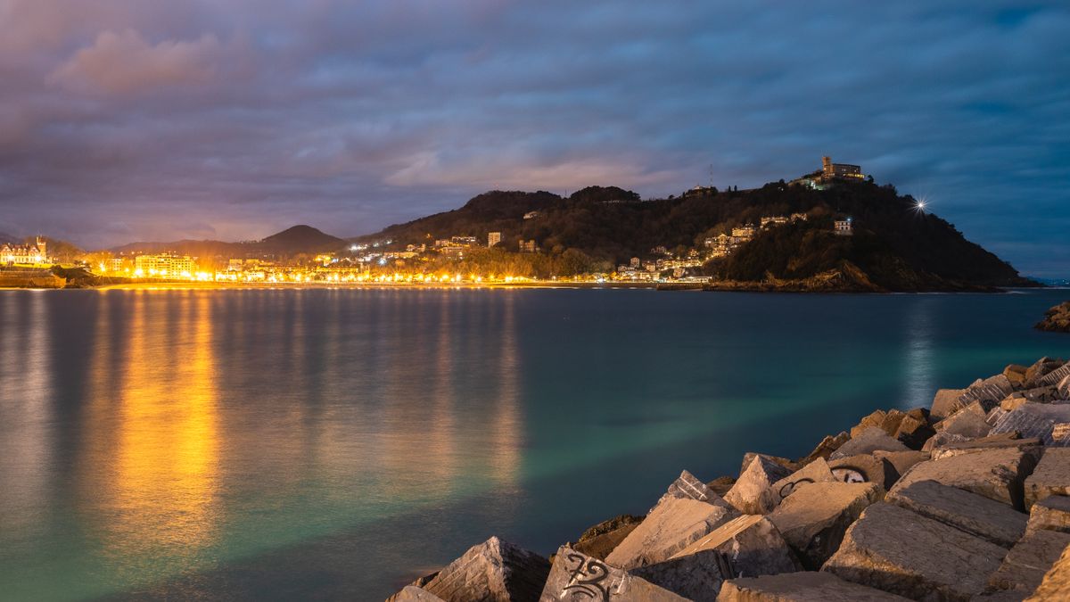 San Sebastian beach and bay with curved coastline and hills in the background