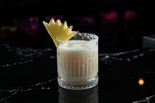 Pina Colada Cocktail Decorated with a Piece of Pineapple 