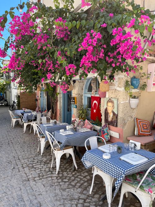 Free Colorful café with bougainvillea and Turkish flag in Alaçatı. Stock Photo