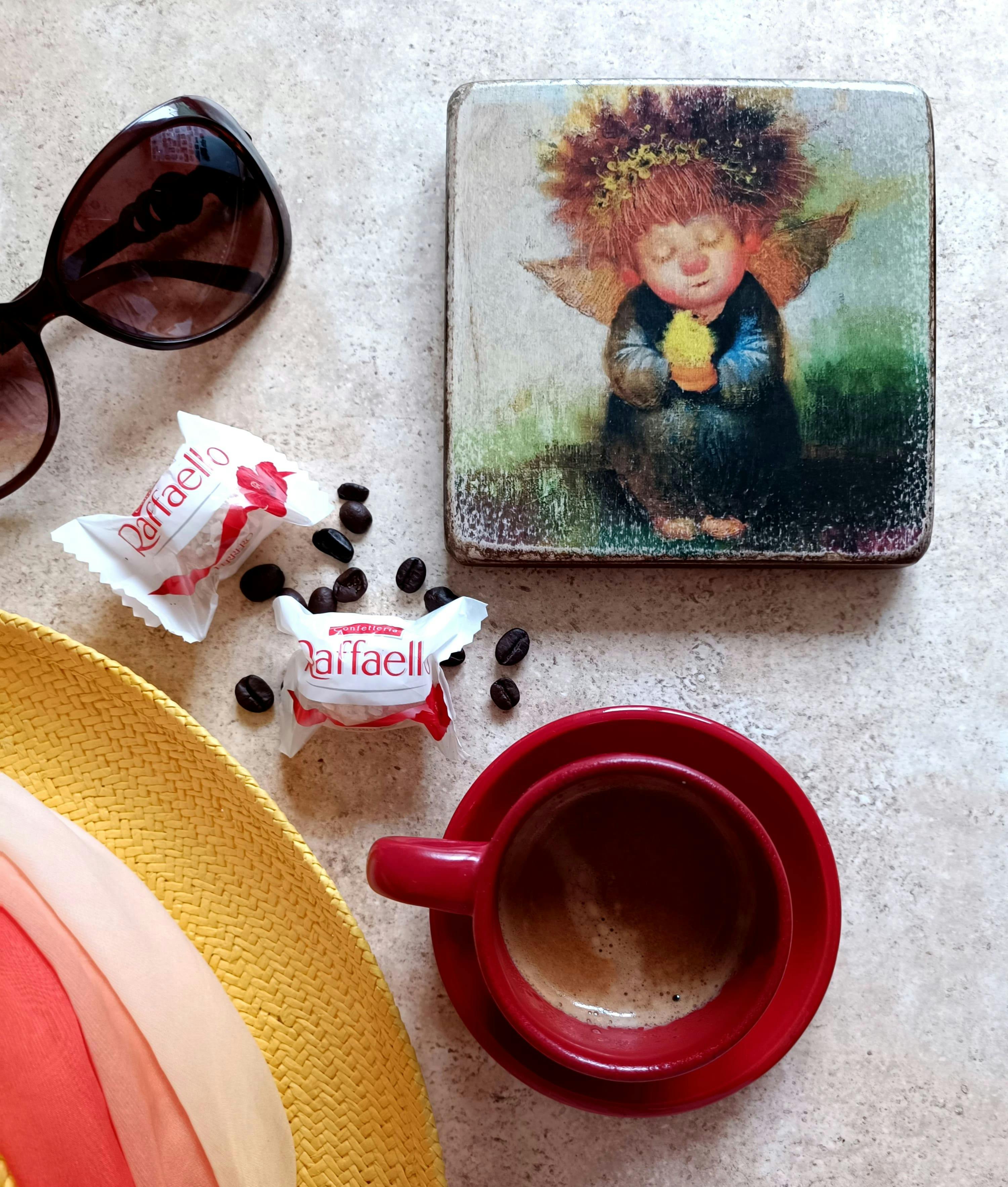 cup of coffee sunglasses chocolate truffles and a coaster with an angel