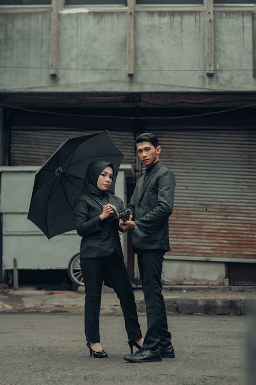 Couple with Umbrella on a Street