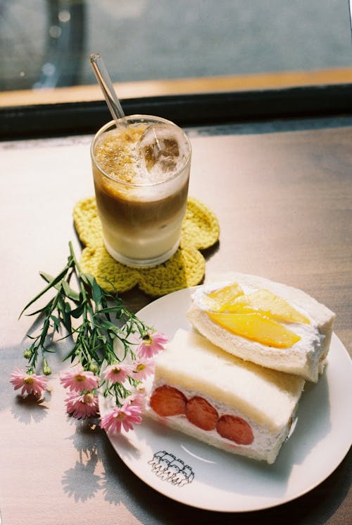 Free Coffee and Cake Slices on a Table in a Cafe  Stock Photo