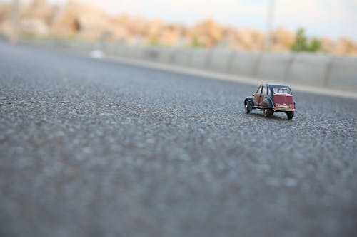 Red and Black Car Die-cast Model on Ground