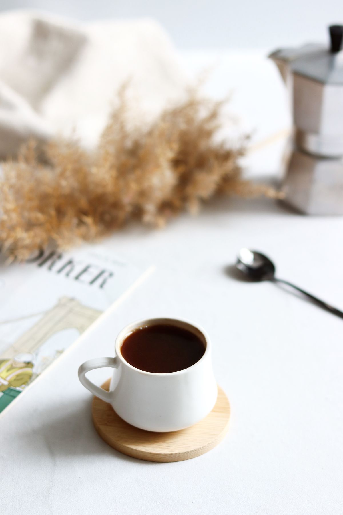 Espresso cup resting on a laser-engraved round wooden coaster