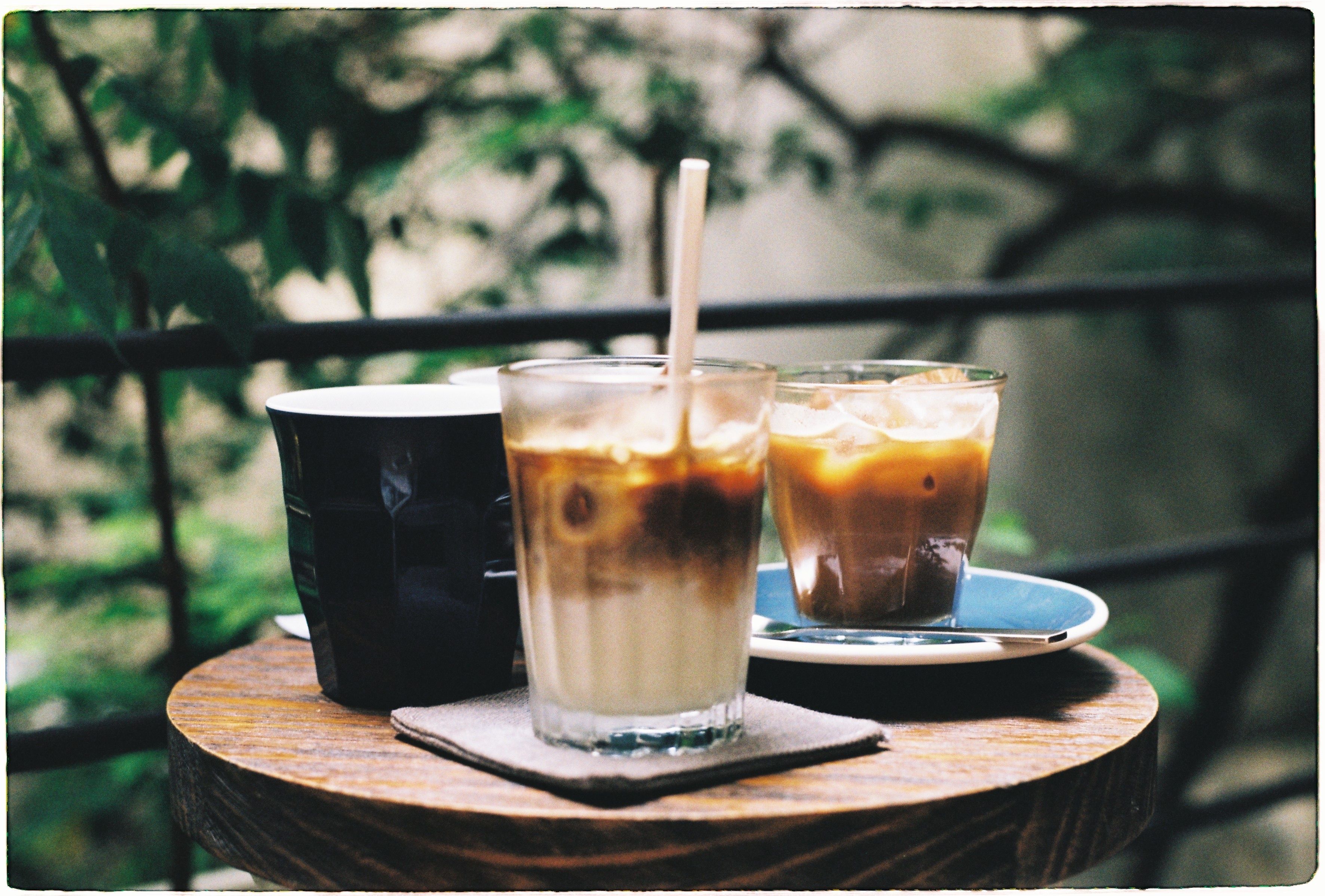 Delight in a refreshing iced coffee on a cozy outdoor balcony table.