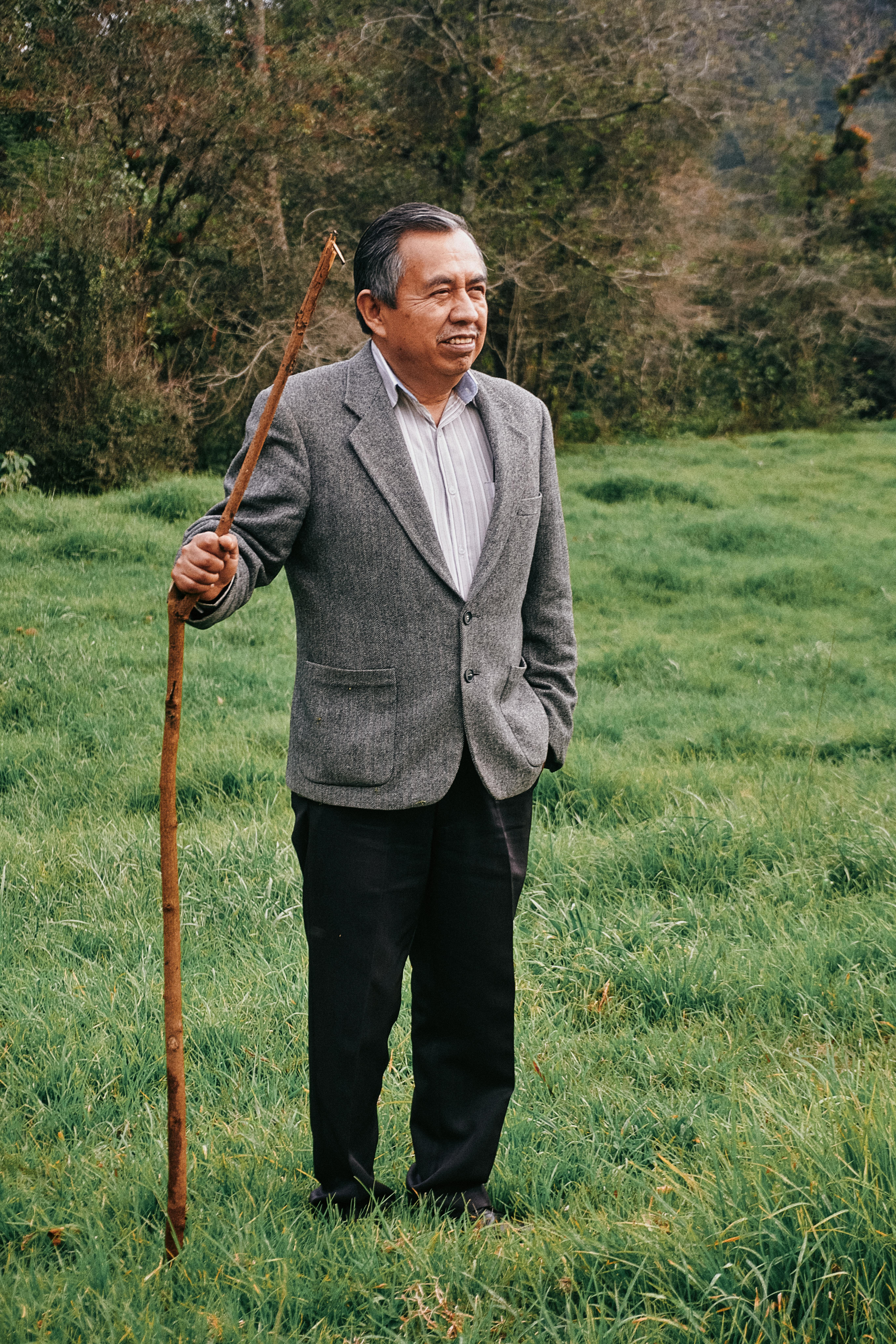 Senior man with a stick standing in a rural field in Veracruz, Mexico.