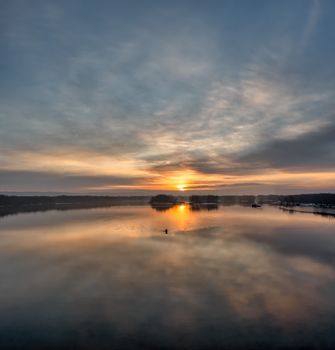 A stunning sunset reflecting over a calm lake at Reads Landing, Minnesota.