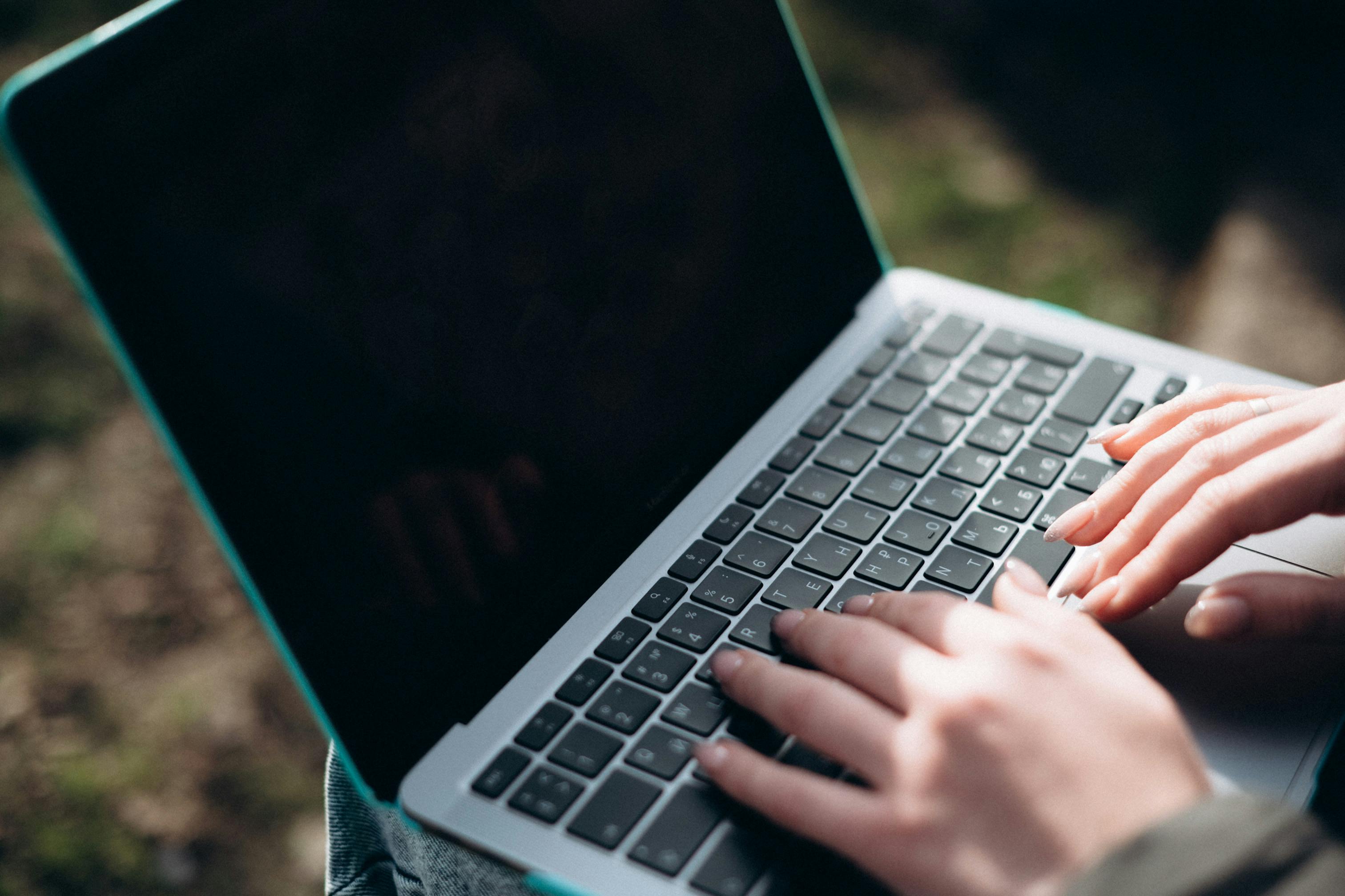 hands on a laptop