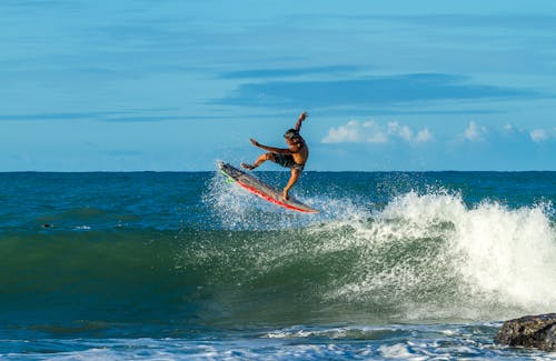 Free Man Surfing during Day Stock Photo