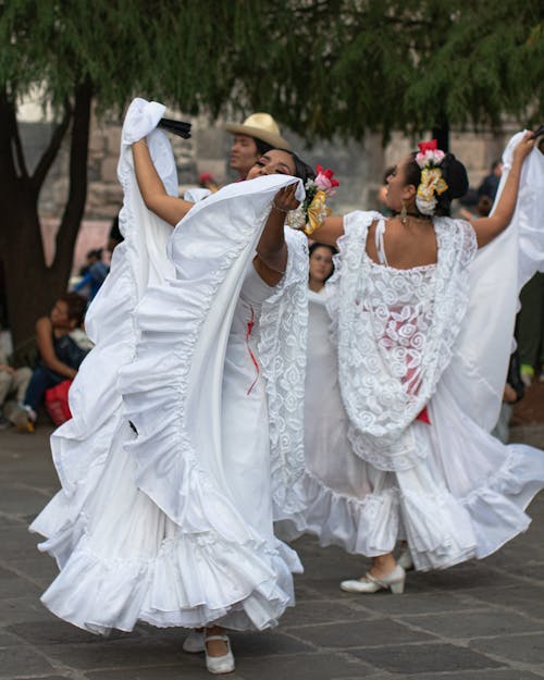 Dancers in White Dresses on Street in Mexico