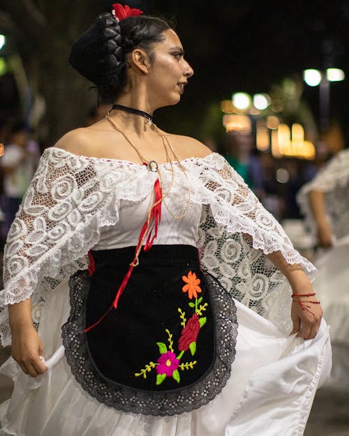 A Woman Wearing Traditional Dress at the Festival