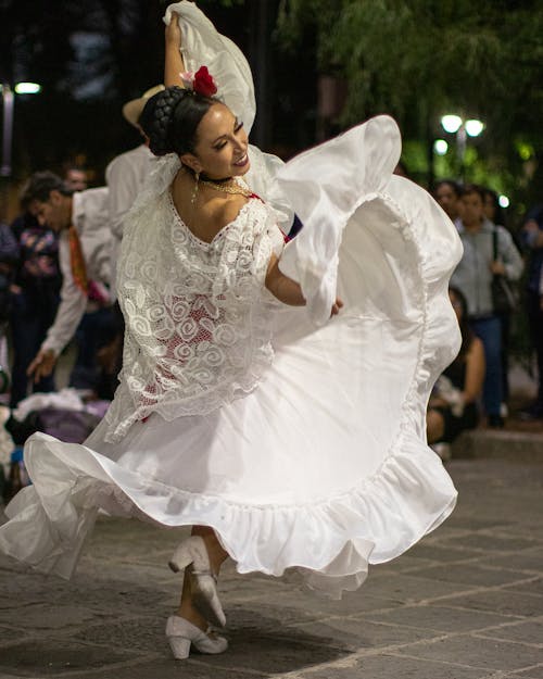 A Woman in a Traditional Dress Dancing on the Stage