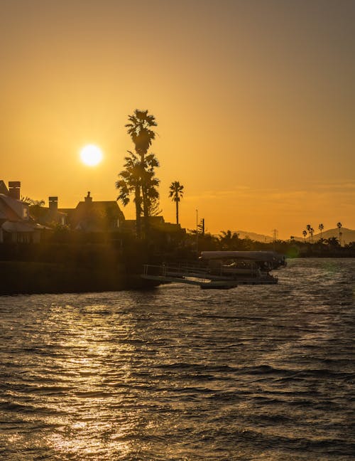 Yellow Sky at Sunset over Village on Sea Shore