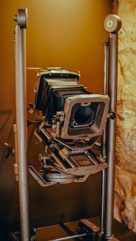 Classic large format camera showcased in a retro setting.