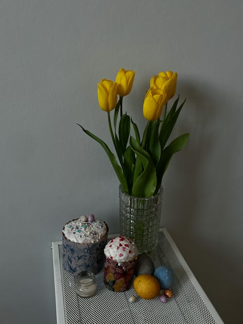 Yellow Tulips and Easter Eggs on a Table 