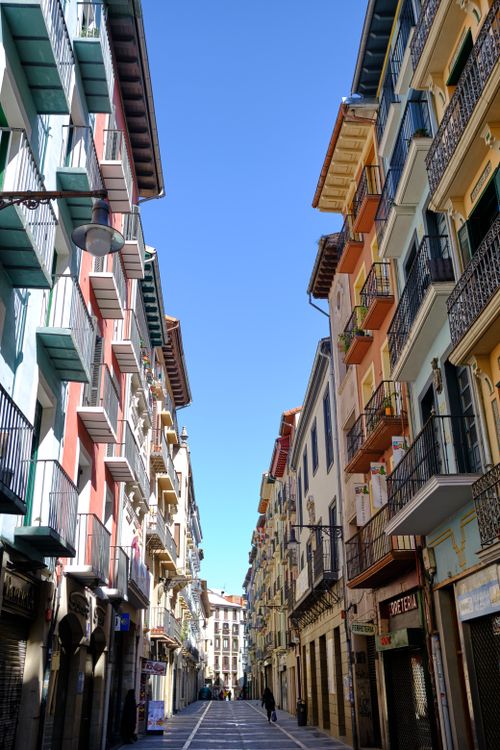 Free Vibrant summer street in Pamplona featuring colorful residential buildings under a clear blue sky. Stock Photo