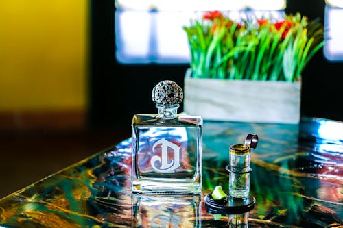 Clear Glass Perfume Bottle on Table