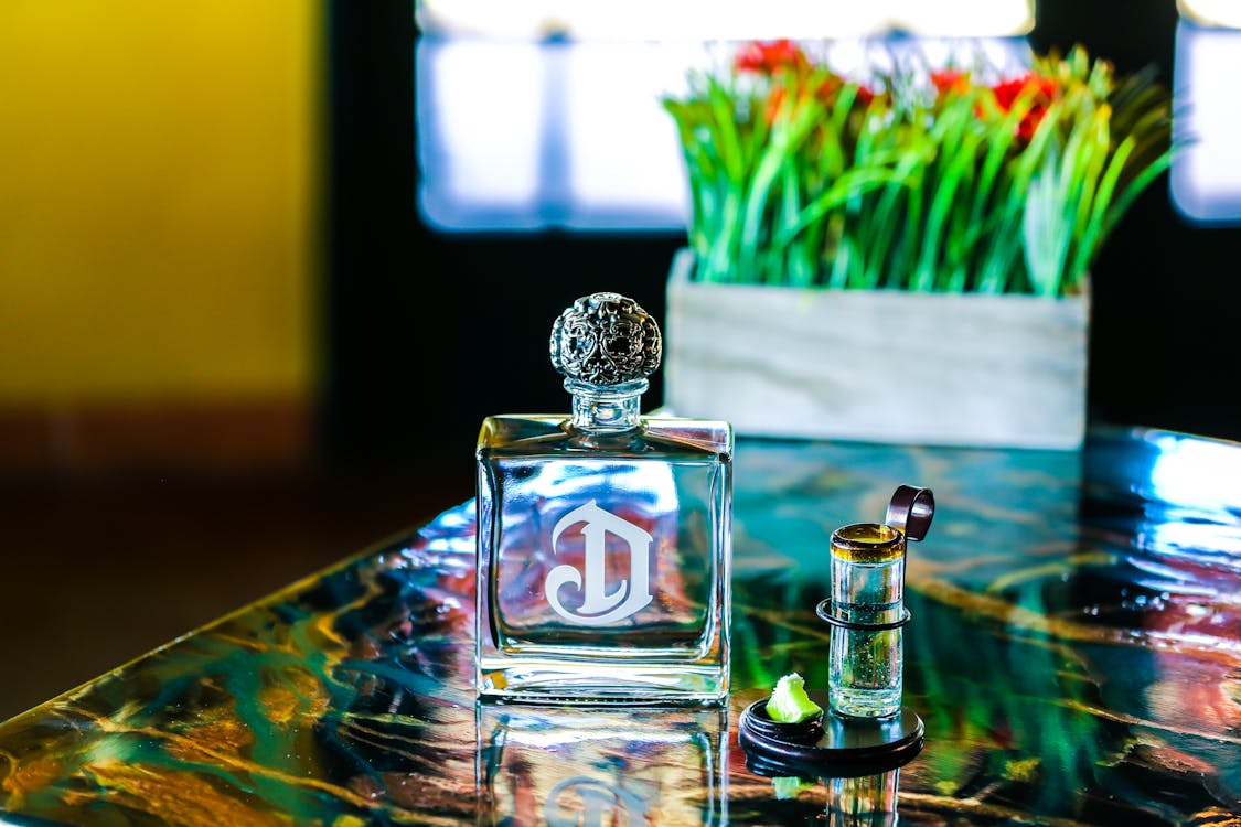 Free Clear Glass Perfume Bottle on Table Stock Photo