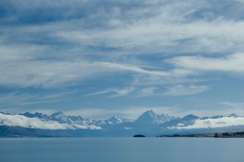 Free Scenic view of snowcapped Aoraki / Mount Cook and Lake Pukaki under blue skies in New Zealand. Stock Photo