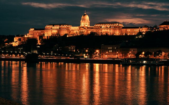 Photo: Incze Sándor Zoltán on Pexels Buda Castle glowing at night, reflecting on the Danube River in Budapest, Hungary.