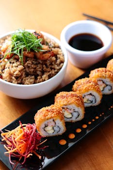 Delicious crispy sushi rolls served with fried rice and soy sauce, perfect for Japanese cuisine enthusiasts.
