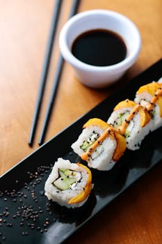 Close-up of sushi roll with soy sauce, perfect for Japanese cuisine lovers.