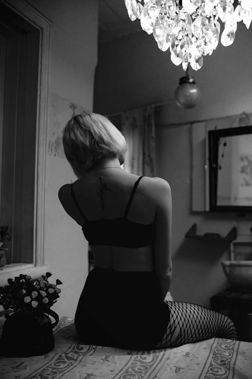 Woman in Lingerie on Bed in Black and White