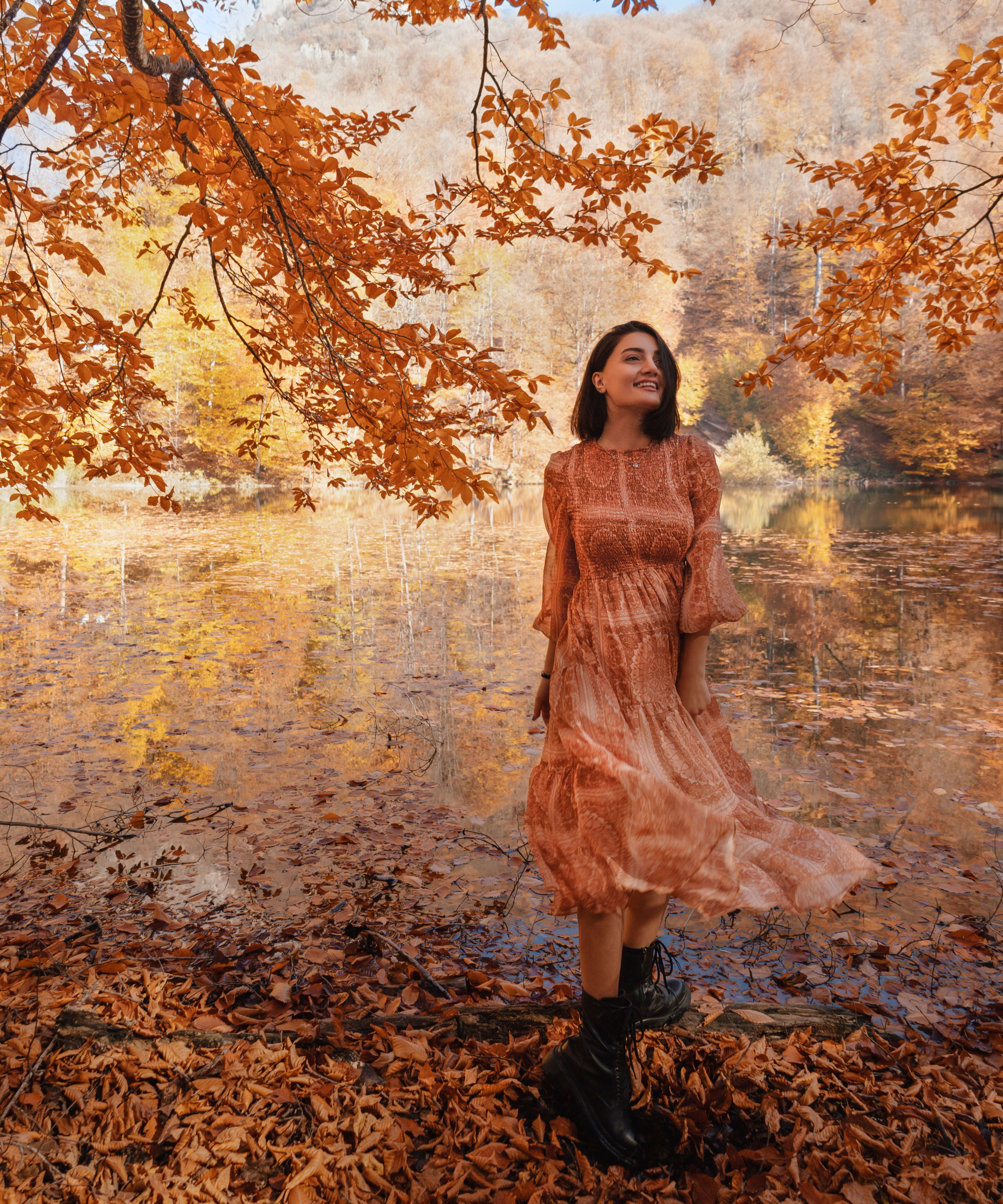 Young Woman in a Dress Standing by the Pond in the Park in Autumn  Free  Stock Photo