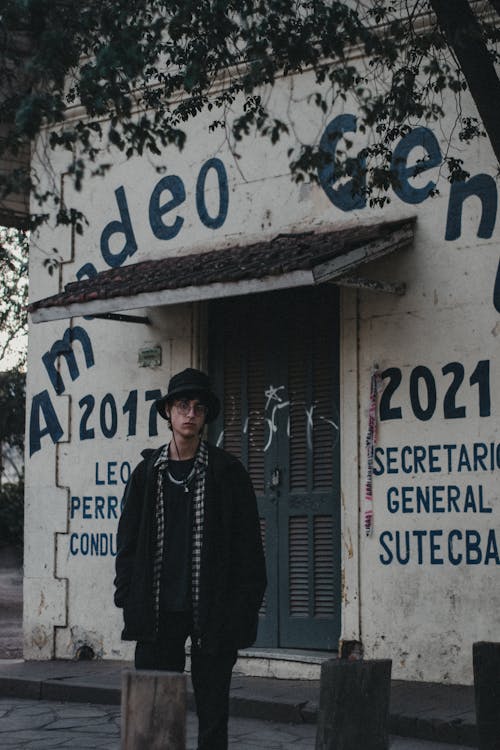 Man in Black Clothes Standing near Building