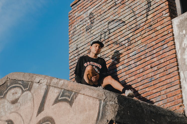 Casual Style Man Sitting On Rooftop