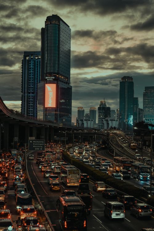 Free Dynamic view of Jakarta's bustling cityscape during dusk, showcasing heavy traffic and towering skyscrapers. Stock Photo