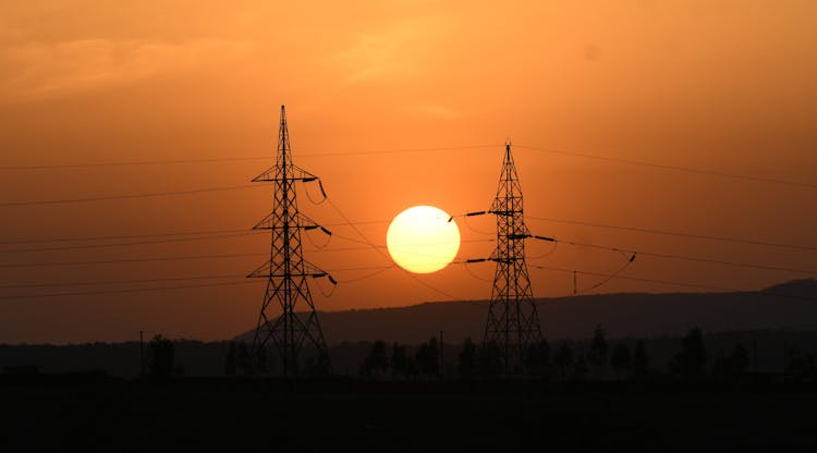 Electricity Pylons At Sunset